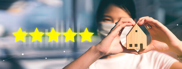 Focus on hand holding house model with 5 star customer review for residentail investment property service banner background