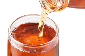 Pouring lemon tea into glass with white background