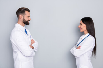 Profile side view portrait of two attractive cheerful experienced doctors folded arms team support...