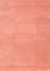 Plastered, weathered and painted pinkish, reddish peach colored concrete wall. Abstract high resolution full frame textured background. Copy space.