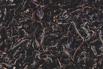 dried black tea on a white acrylic background