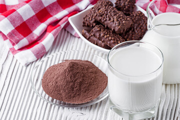 chocolate cocoa milk powder on a white wooden rustic background