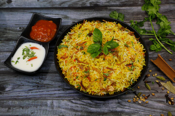 Hyderabad Chicken Biryani with yogurt and tomato gravy
