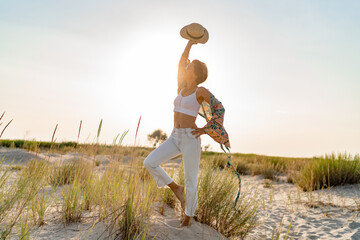Fototapeta premium stylish attractive slim smiling woman on beach in summer style fashion trend outfit