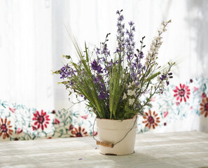 Still life with fresh wild flowers in vase