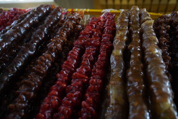 Almaty, Kazakhstan - 03.25.2022 : A type of Georgian sweet - churchkhela. Nuts in frozen syrup.