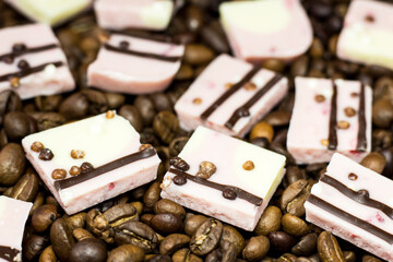 Pink chocolate pieces and coffee beans