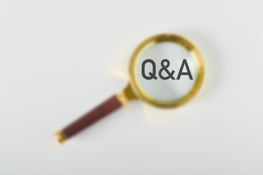 Blurred image of magnifying glass with text Q&A