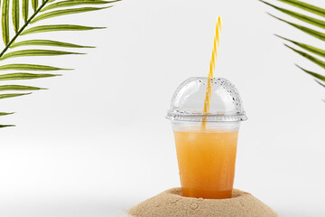 glass of orange juice with straw