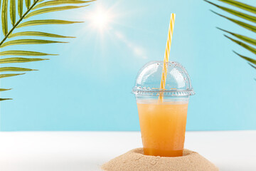 glass of orange juice on the beach