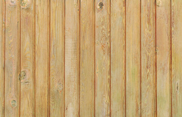 Background. The texture of an old wooden wall made of lacquered lining. Close-up.