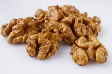 dried walnuts on a white acrylic background
