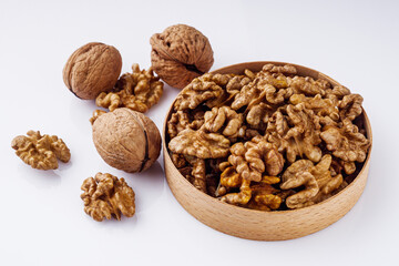 dried walnuts on a white acrylic background