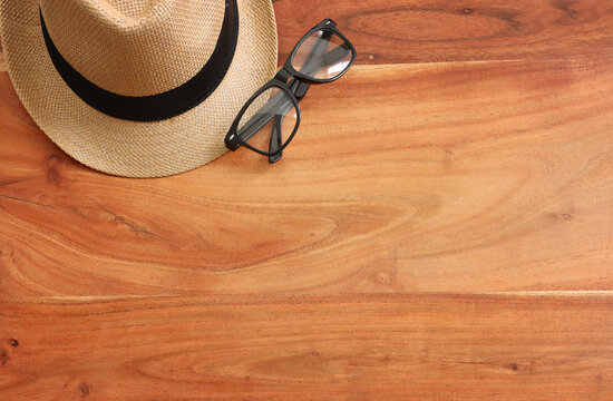 Father's day concept with fedora hat and glasses over wooden background. top view, flat lay