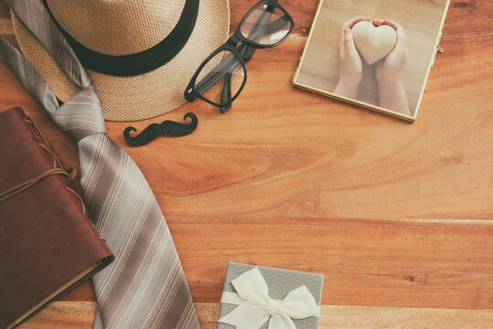 Father's day concept with fedora hat and necktie over wooden background. top view, flat lay