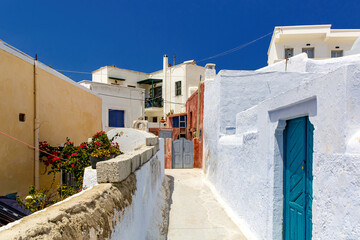 Walking through Santorini streets. Traditional Greek white houses architecture. - obrazy, fototapety, plakaty