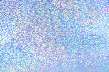 Holographic iridescent abstract glitter background in blue purple color with fine blurred texture