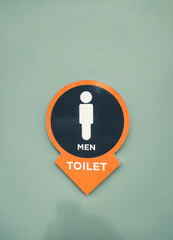 Man restroom signage in a park in the city