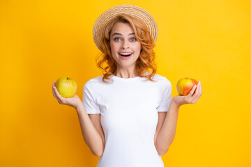 Smiling redhead woman with healthy teeth holding apple. studio isolated portrait.