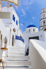 Walking through Santorini streets. Traditional Greek white houses architecture.