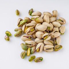 fresh salted pistachios on a white background