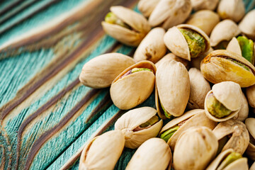 fresh salted pistachios on a wooden rustic background