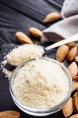 almond flour on a black wooden rustic background