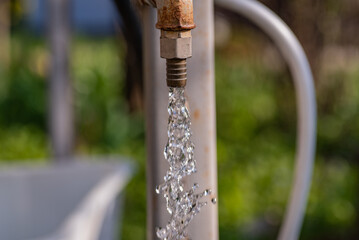 Drinking water pours from a pipe, horizontal shot