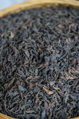 Pile of dried Chinese black tea leaves closeup