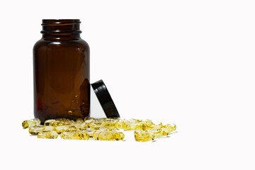 gel tablets and a brown tablet bottle isolated on a white background