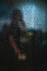Window in a rainy day, water drops on defocused background