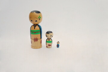 Three Wooden Asain Influenced Nesting Dolls on White Background with Room for Text