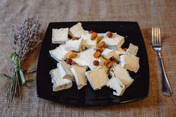 Camembert, French soft cheese with white mold and traditional French goat Valencay cheese cut into...