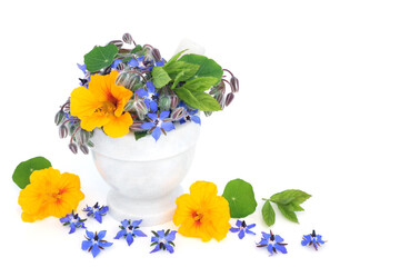 Nasturtium and borage herb flowers in a mortar. Immune system boosting, anti inflammatory,...