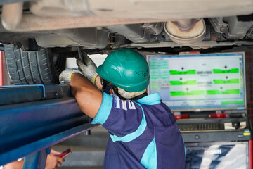 mechanic has checked the camber wheel alignment in the service station,automotive mechanic education concept