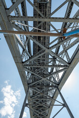 View of the Luís I Bridge from below on a sunny day in Porto, Portugal