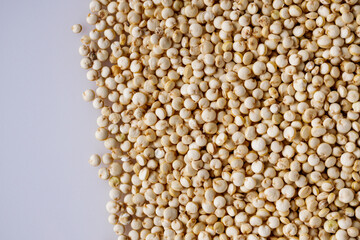 white quinoa seeds on a white acrylic background