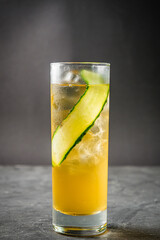 bright colored alcoholic cocktail on a black stone background