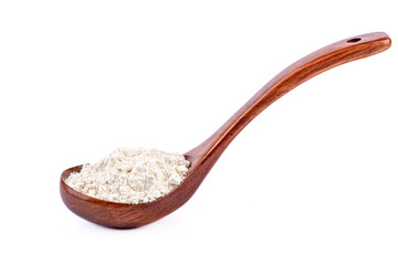 Wooden spoon full of wheat flour on a white background.