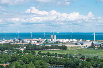 Areal view of offshore wind turbines power in a row in the Baltic Sea in an industrial district of...