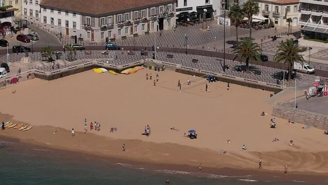 Aerial view of unidentifiable people on Ribeira Beach in Cascais, Portugal on a sunny day