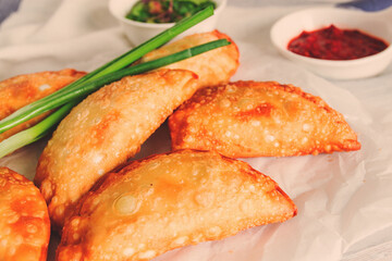 Fried chebureks, close-up, on a light background, no people,