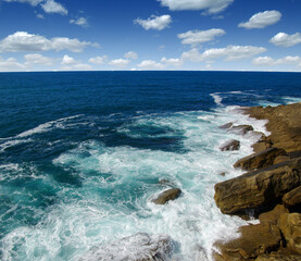 ocean wave crashing on rock