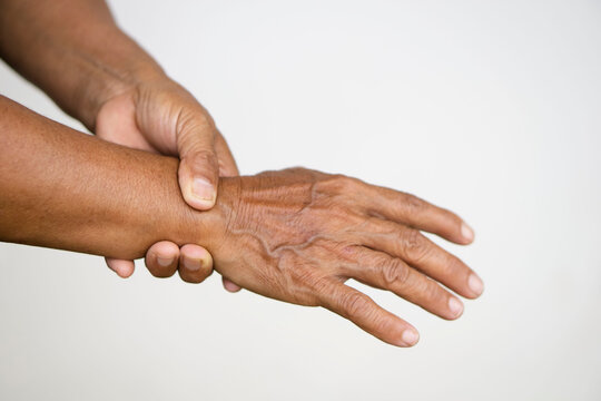 Closeup elderly hands  massage painful wrist. Concept : health problem. Senior healthcare.  Massage for relieve of  hurt or painful. Wrist symptomatic.
