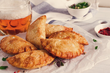 Fried chebureks, close-up, on a light background, no people,
