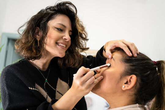 Makeup artist and client during eyeshadow application