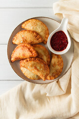 Fried chebureks, close-up, on a light background, no people,