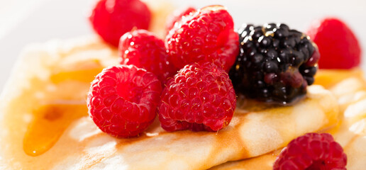 pancakes with raspberries, blackberries and honey