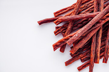 dried fish beer snack on a white acrylic background