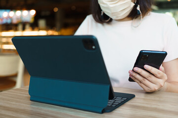 Young Freelancer or Businessman working at home office and typing on keyboard smartphone tablet. Working Online Or Studying And Learning While Using smartphone tablet. Freelance Work, Business concept